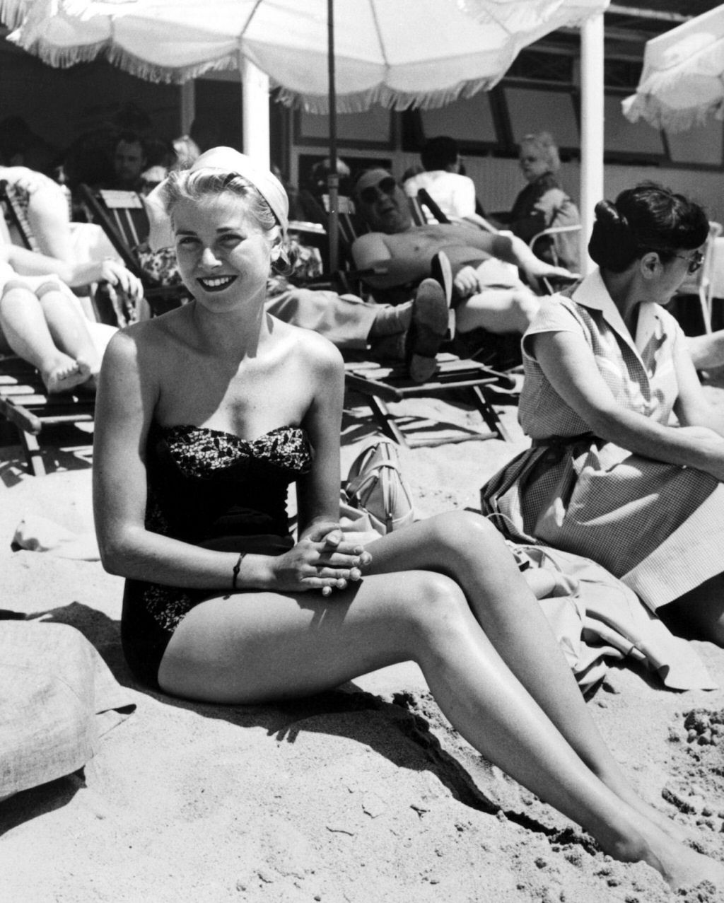 Elegant style icon wardrobe essentials: Grace Kelly in swimwear, a strapless lace one piece swimsuit, photo by Edward Quinn, 1954