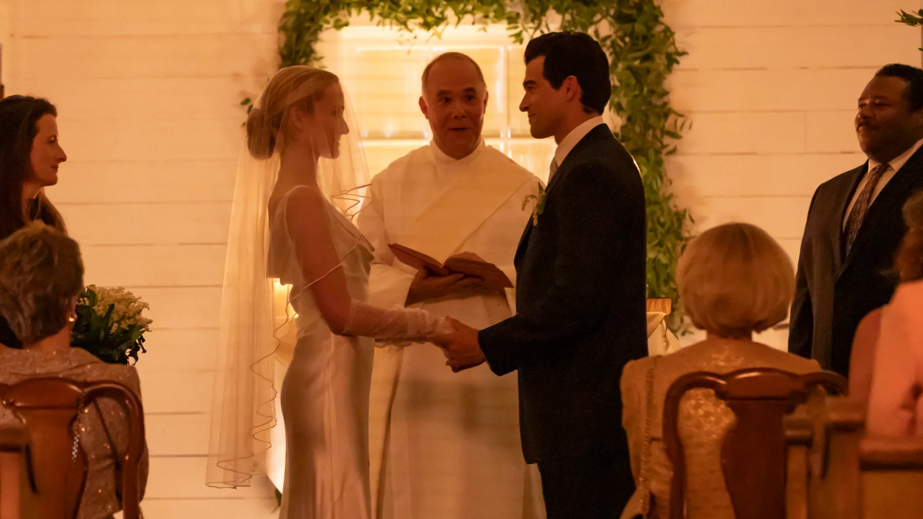 Sarah Pidgeon as Carolyn Bessette in a white slip wedding dress and veil with Paul Anthony Kelly as John F. Kennedy Jr. in Love Story (TV series, 2026)