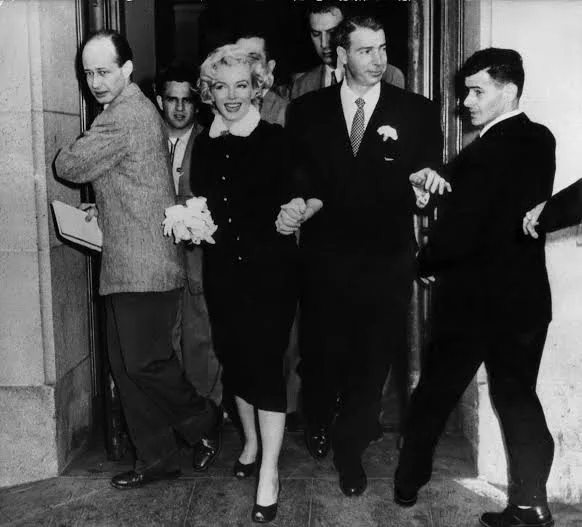 Marilyn Monroe with Joe DiMaggio on their wedding day, 1954