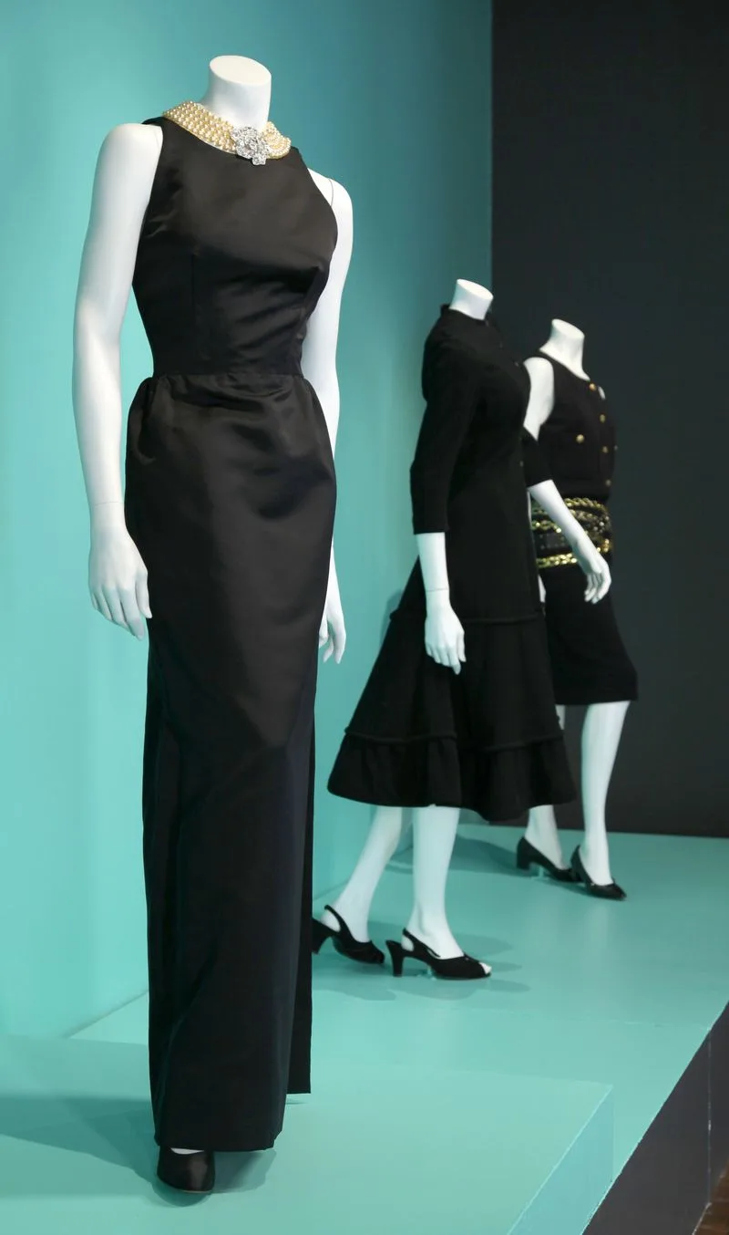 The black Givenchy dress from Breakfast at Tiffany's on display with other dresses