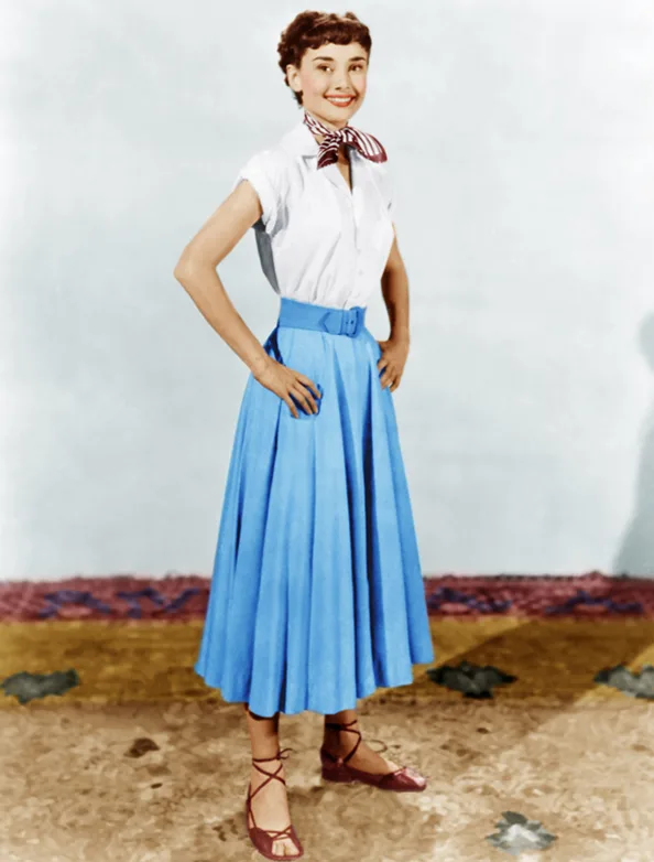 Colorized photo of Audrey Hepburn in a white shirt and sky blue circle skirt, Roman Holiday