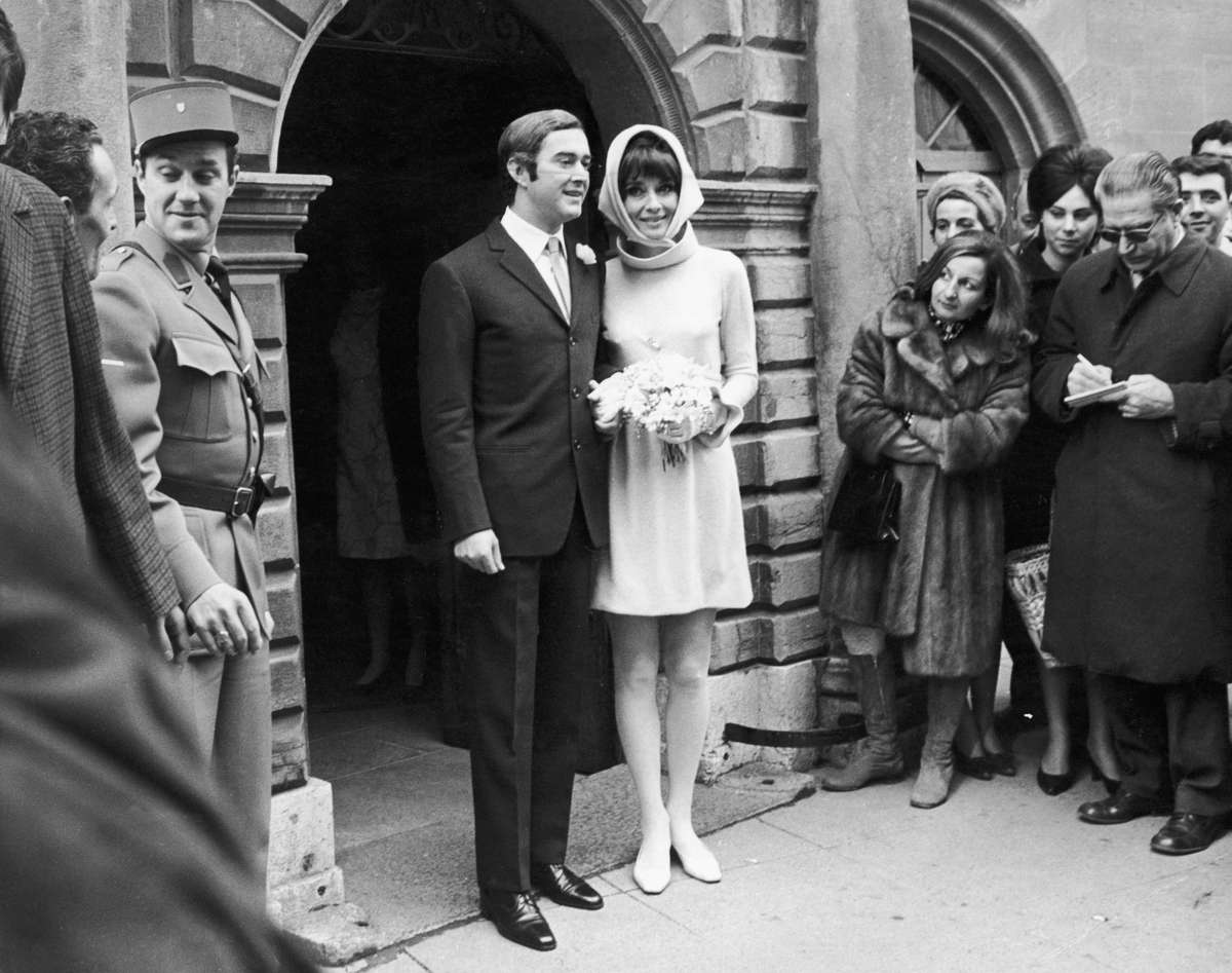 Audrey Hepburn in a pale pink Givenchy minidress and headscarf with Andrea Dotti on their wedding day, 1969