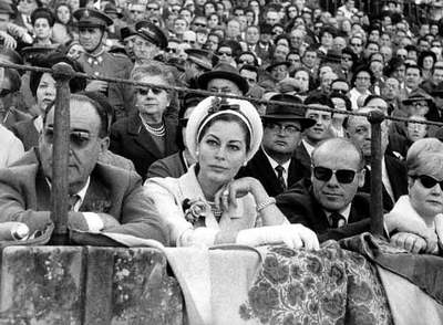Ava Gardner in a headscarf watching a bullfight in Spain