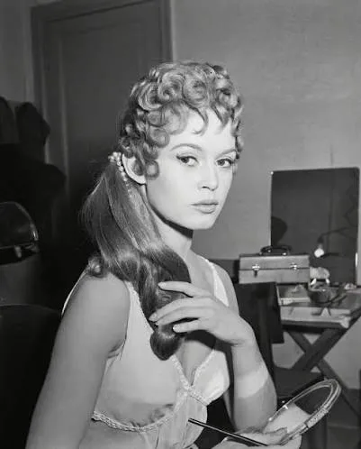 Brigitte Bardot, newly blonde, in her dressing room during the filming of Nero's Weekend, 1956