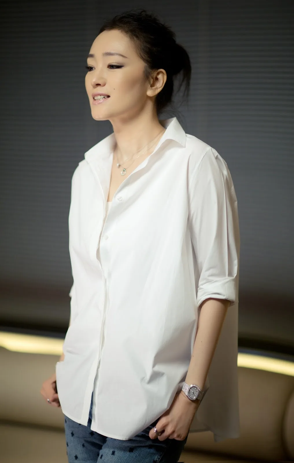 Gong Li in a loose white shirt and jeans, portrait