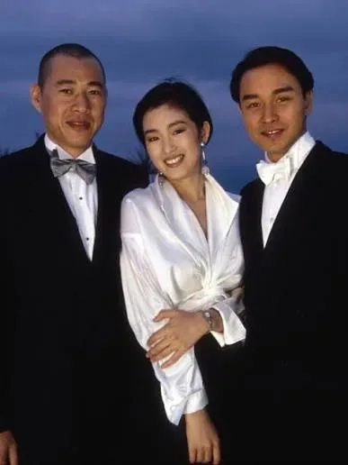 Gong Li in a white shirt with Zhang Fengyi and Leslie Cheung at Cannes, 1993