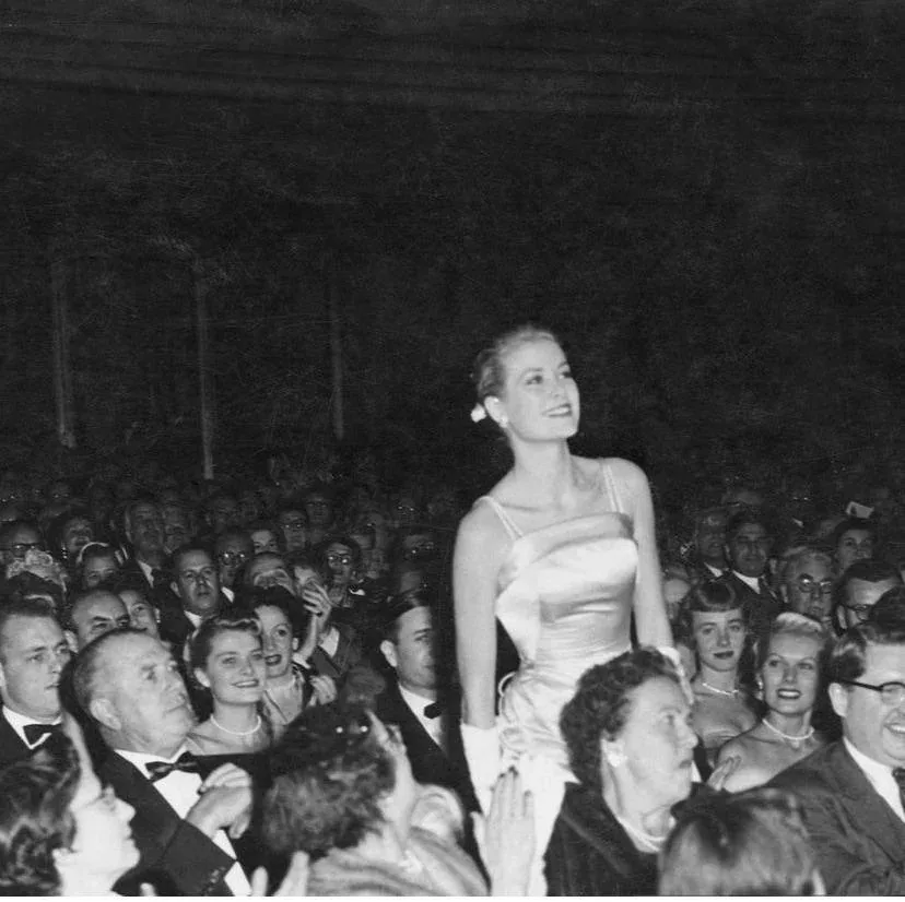 Grace Kelly in her satin gown and matching coat at the premiere of The Country Girl, New York, 1954
