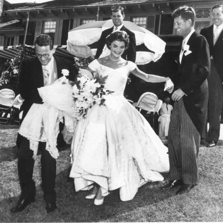 Jacqueline Bouvier and John F. Kennedy surrounded by guests at their wedding reception, 1953