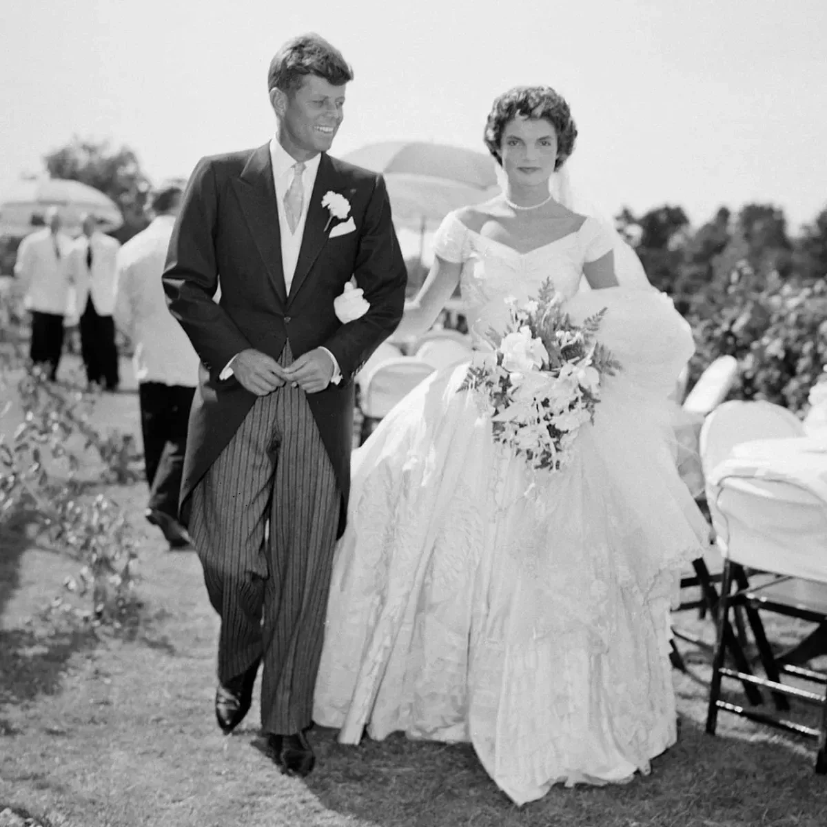 Jacqueline Bouvier and John F. Kennedy walking across the lawn at Hammersmith Farm, 1953