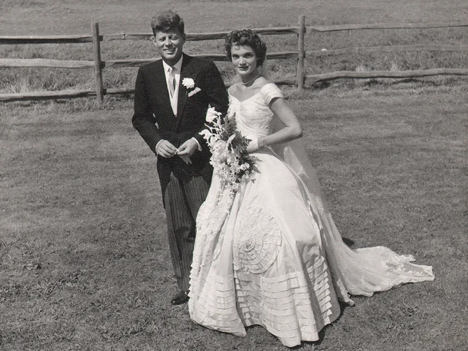 Jacqueline Bouvier and John F. Kennedy standing on the lawn at Hammersmith Farm, 1953