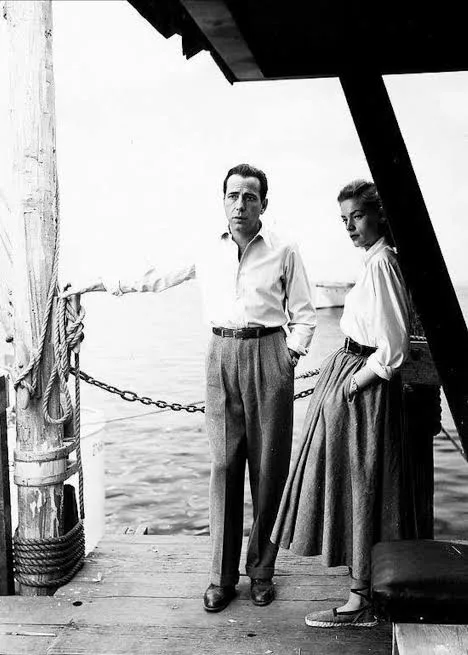 Lauren Bacall in a white shirt and pleated skirt with Humphrey Bogart, Key Largo (film, 1948)