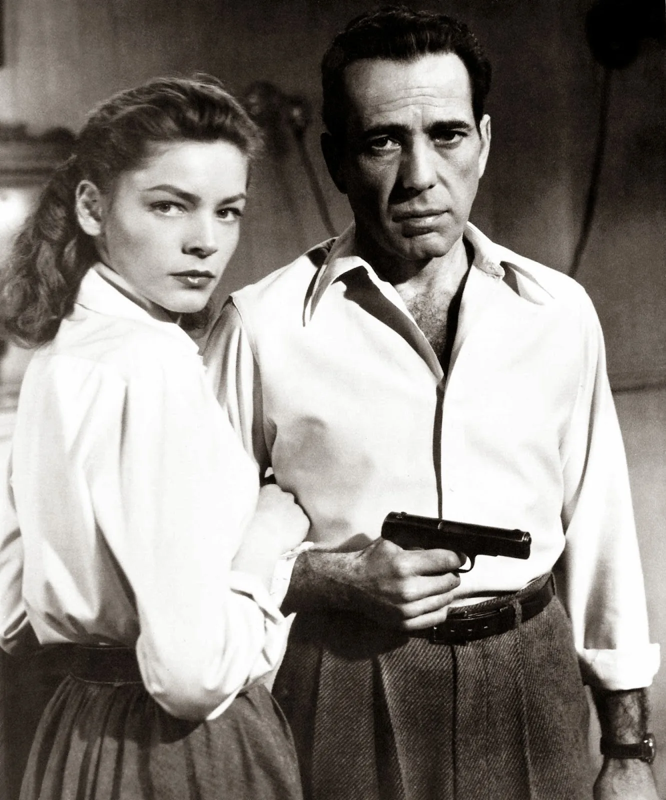 Lauren Bacall in a white shirt with Humphrey Bogart holding a gun, Key Largo (film, 1948)