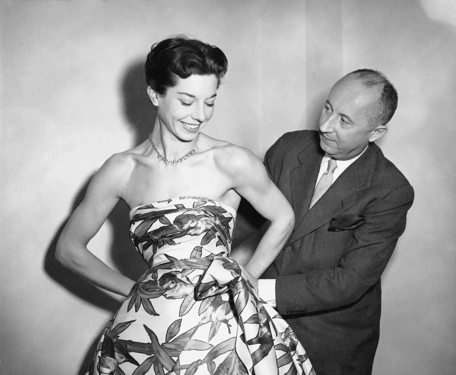 Christian Dior with model Dorothy Emms, 1952