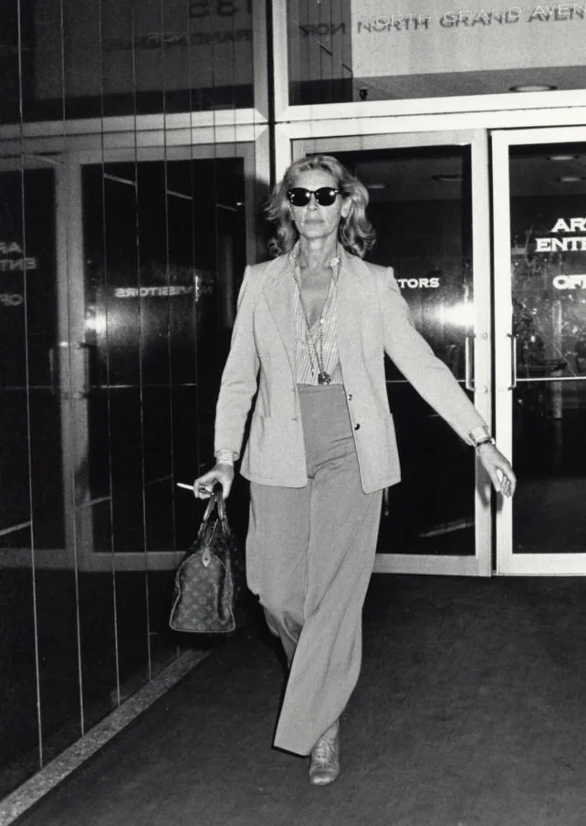 Lauren Bacall in a tailored pantsuit with wide trousers in the 1970s, her signature personal style