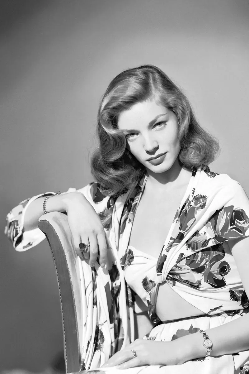 Lauren Bacall in 1944 with her chin lowered and eyes raised, the pose known as The Look