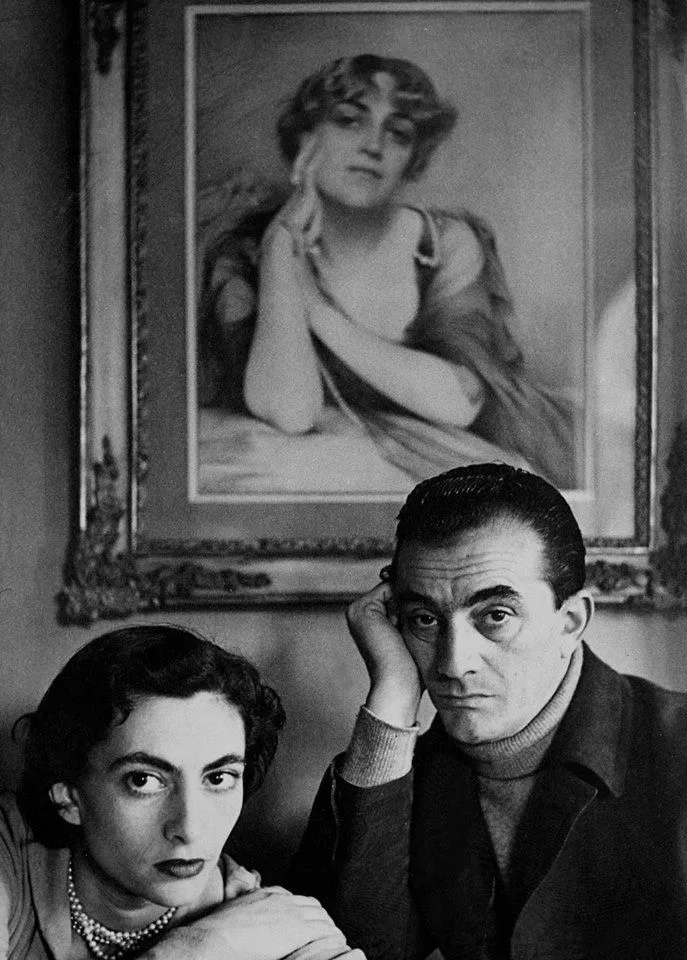 Luchino Visconti and his sister in front of a portrait of their mother Carla Erba