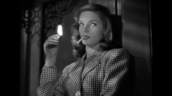 Lauren Bacall in 1944, chin lowered and eyes raised, the pose known as The Look, To Have and Have Not (film, 1944)