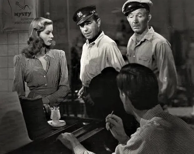 Lauren Bacall, Humphrey Bogart and Walter Brennan leaving the hotel in To Have and Have Not (film, 1944)